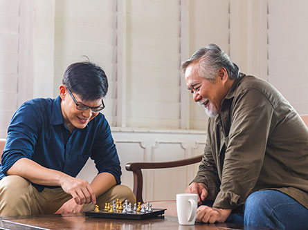 father and son playing chess
