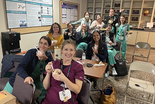 Residents enjoy a break from teaching conference while eating ice cream.