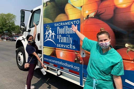 Pritha Multani, M.D. and Anna Lepkowski, M.D. (2023) volunteer with Sacramento Food Bank & Family Services.