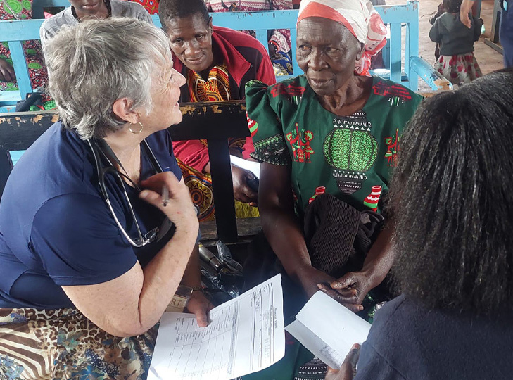 Associate Professor Laura Van Auker talking to people in Kenya