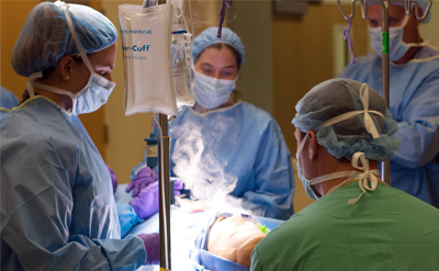 Clinicians practice ENT surgical procedures on a mannequin. (C) UC Davis Regents.