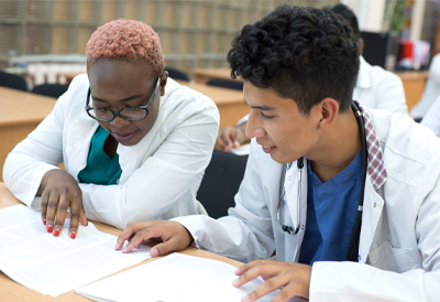 Two medical students working together at a desk (c) UC Davis Regents. All rights reserved. 