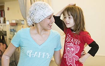 Pediatric cancer patient Paislee Schumann models her new T-shirt