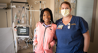 Nurse Amy Delacruz with pediatric patient Amie Sesay.