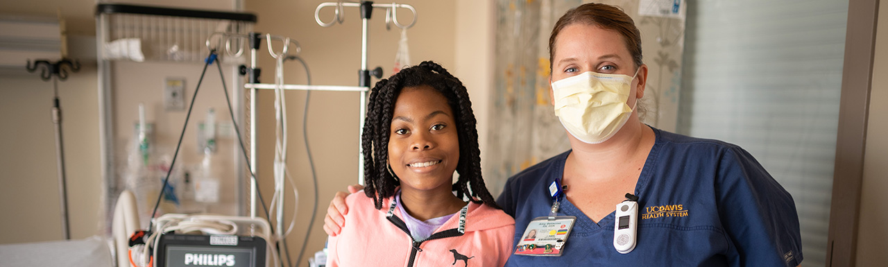 Nurse Amy Delacruz with pediatric patient Amie Sesay