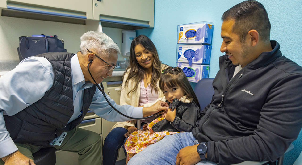 Frank Ing, M.D., chief of pediatric cardiology with patient Grace and her family.