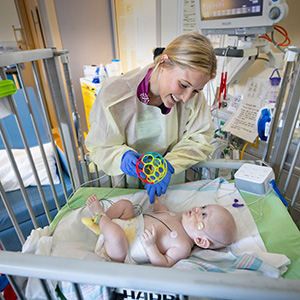 Pediatric Intensive Care nurse taking care of a patient