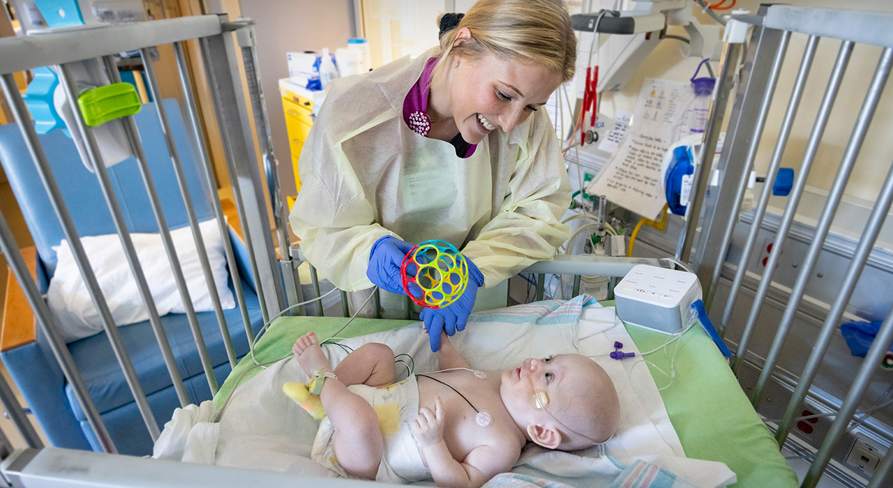 Pediatric Intensive Care Unit nurse taking care of a baby