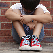 stock image of a child with his head down