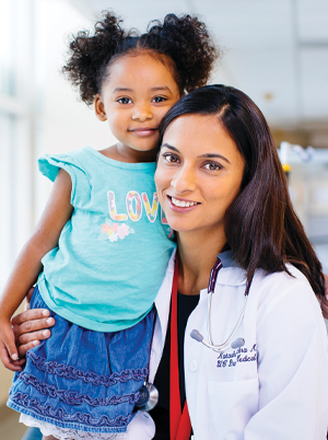 Child with doctor smiling (c) UC Regents. All rights reserved.