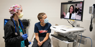 Nurse and pre-teen telehealth visit with doctor. (C) UC Regents. All rights reserved.