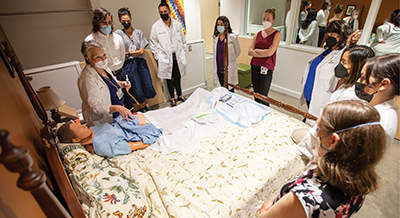 UC Davis Health nurse practitioner residents practice GI tube management in a Betty Irene Moore School of Nursing simulation suite.