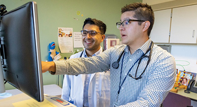 UC Davis Health pediatrician Sean Muñoz, pictured right, with medical student Andrés Maldondo