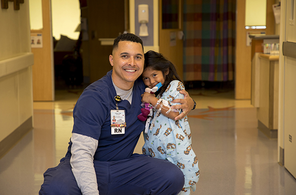 PICU nurse Carter Todd and a pediatric patient