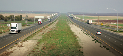 Truck traffic on a smoggy Central Valley stretch of Interstate 5
