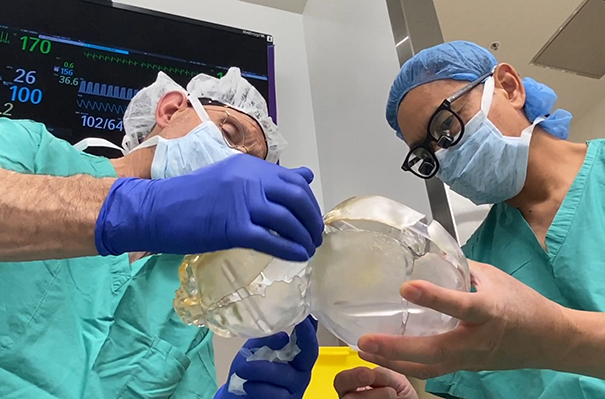Granger Wong, Chief of Plastic and Reconstructive Surgery (right) and Michael Edwards, pediatric neurosurgeon (left) prepare for surgery using 3-D models