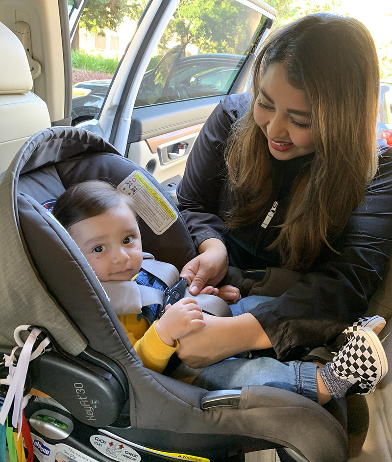 mom and baby with car seat