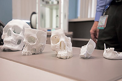 Portions of 3D printed skulls sitting on a table.