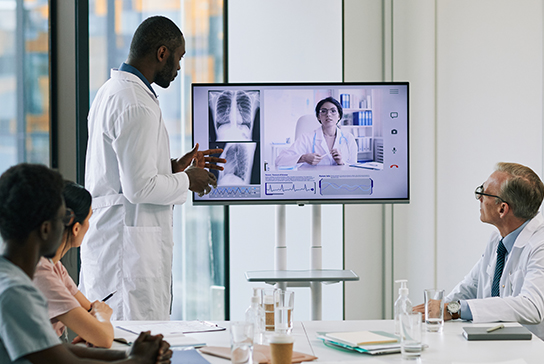 Group of four physicians in a teleconference meeting