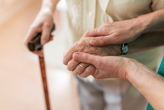 Elderly holding hands