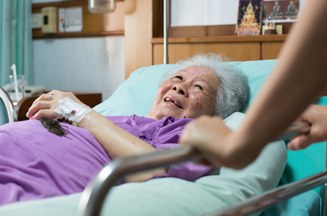 A smiling woman spiritually comforted in her hospital room.