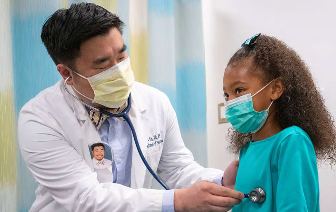 General pediatrician Christopher Kim with patient