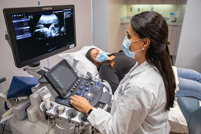 Doctor performing ultrasound on patient