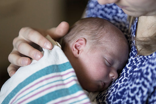 Close-up photo of baby Charlie being held in mom's arms