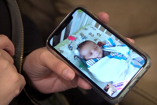 Mom viewing baby on phone