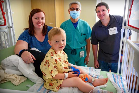 Pediatric heart center doctor with patient and family