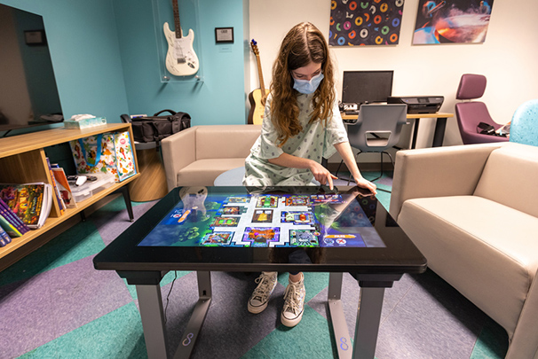 Patient plays in teen lounge