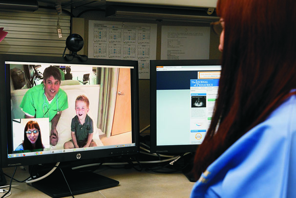 A nurse and PICU doctor on a telehealth video call