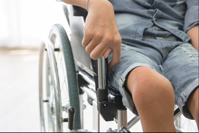 A young person with withered body in a wheelchair.
