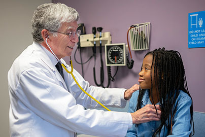 Dr. Dennis Styne provides a check-up with young patient Aubrey in a medical office setting