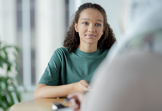 A young teen female in a clinical office for a consultation, stock image
