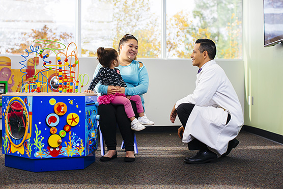 UC Davis Children's Hospital doctor conversing with mother and children