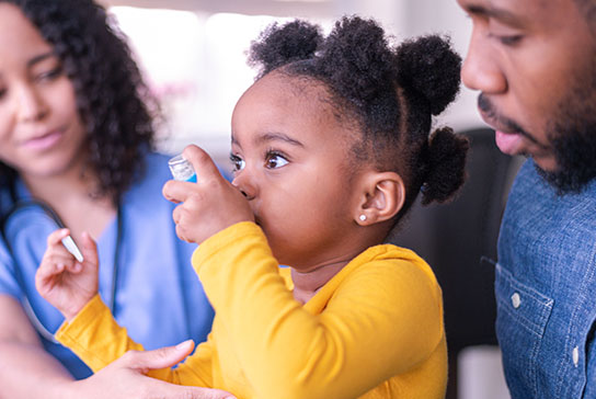 Young patient learning how to use an inhaler