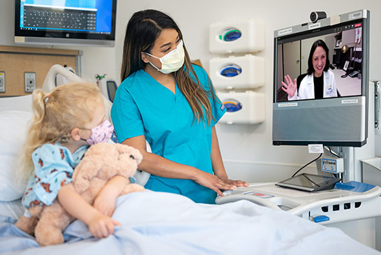 Telehealth consult in medical office with pediatric patient