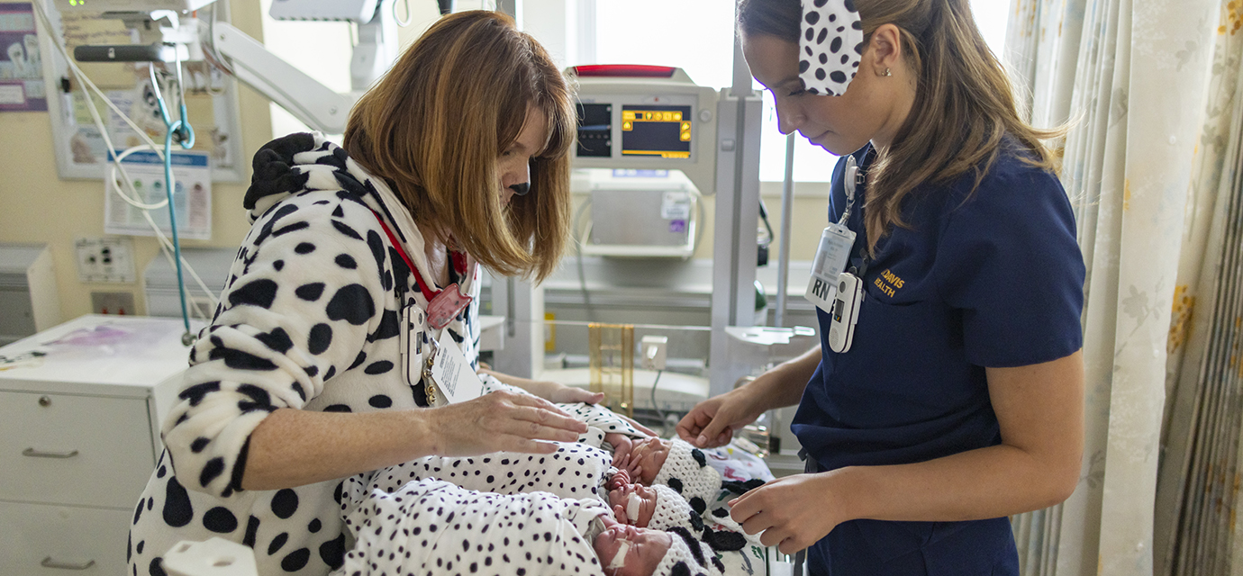 Nurses with babies dressed up like Dalmatians