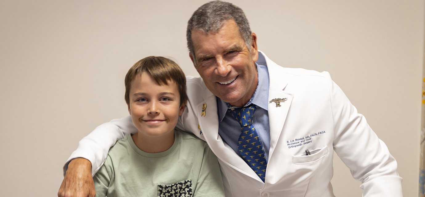 Dr. R. Lor Randall with pediatric orthopaedic patient Ryder.