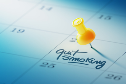 A calendar with a day marked in writing as "quit smoking."