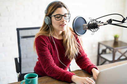 Woman speaking in microphone (C) Adobe stock. All rights reserved.