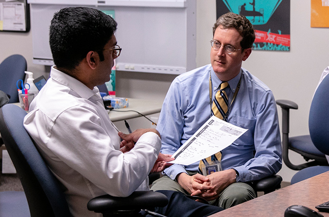 Dr. Stephen Henry works with residents at the general internal medicine clinic.