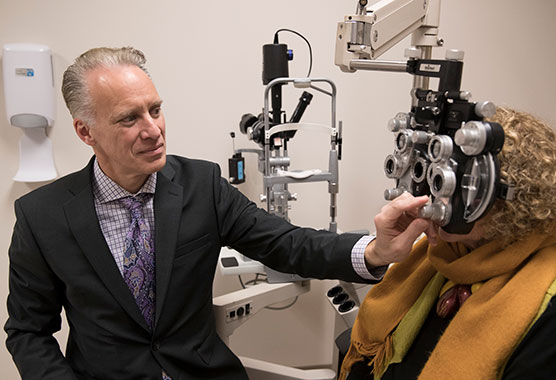 Male provider administering a vision exam to a female patient