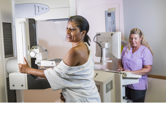 Woman getting a mammogram with another provider nearby