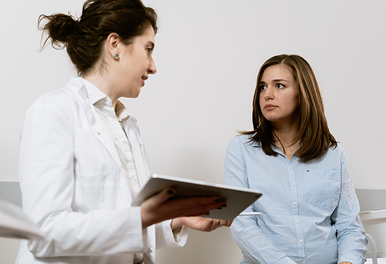 Female patient speaking to a female physician.