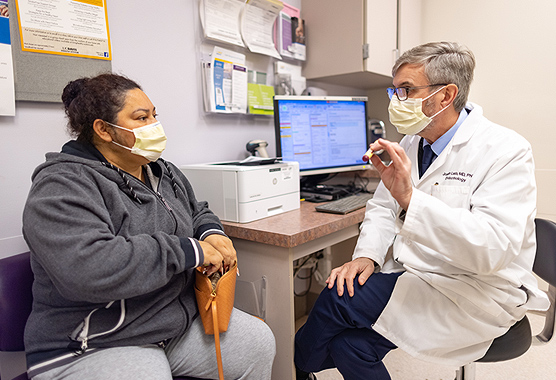 Male endocrinologist talking to female patient about Cushing Syndrome.