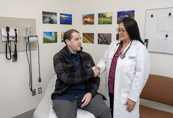 Health care provider shaking hands with male patient to discuss glomerular diseases.