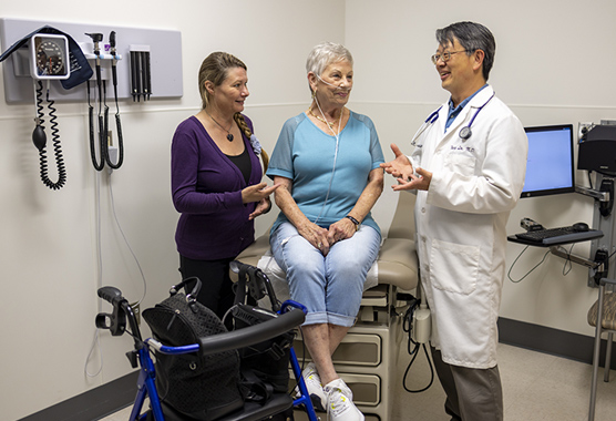 Older woman in a clinic talking to her health care provider about Hashimoto’s Disease