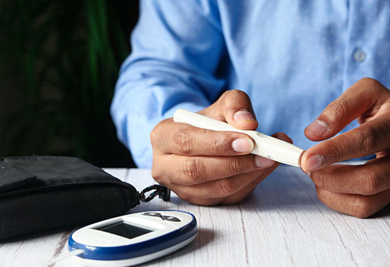 Man with hypoglycemia pricking his finger to check his blood glucose levels.